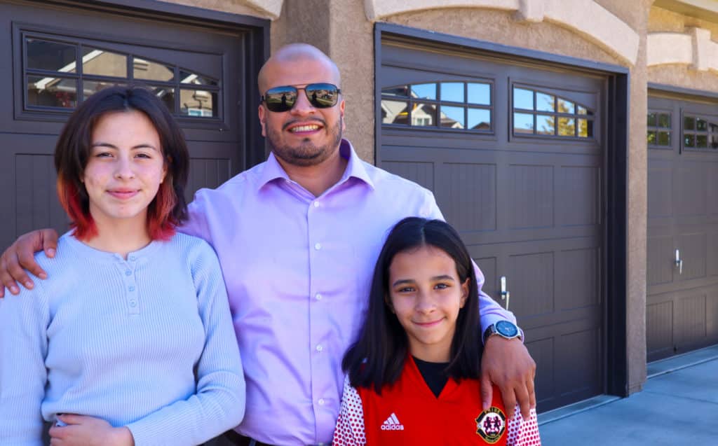 photo of man smiling with 2 young girls